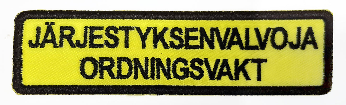 Järjestyksenvalvoja brodeerattu 2-kielinen kangasmerkki ALE ERÄ